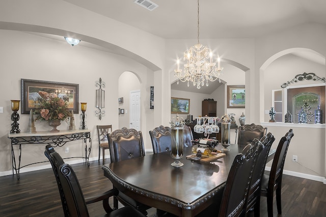 dining area featuring an inviting chandelier, arched walkways, baseboards, wood finished floors, and visible vents