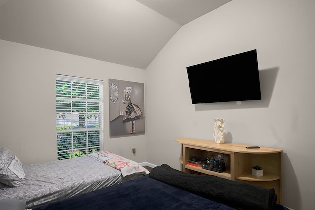 bedroom with baseboards and vaulted ceiling
