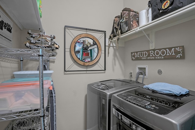 clothes washing area with laundry area and washer and clothes dryer