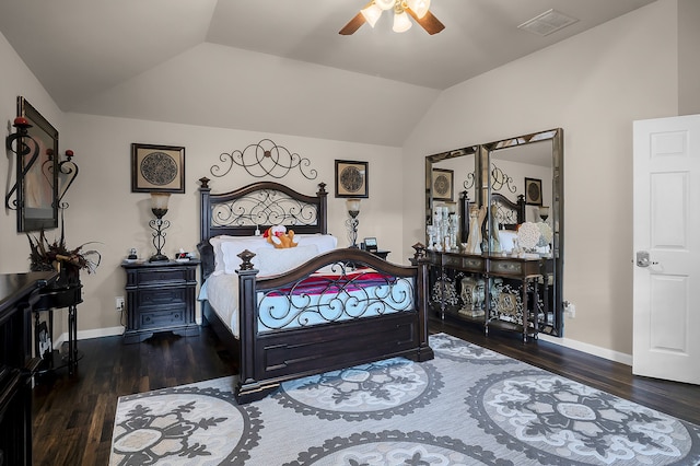 bedroom featuring baseboards, vaulted ceiling, wood finished floors, and visible vents