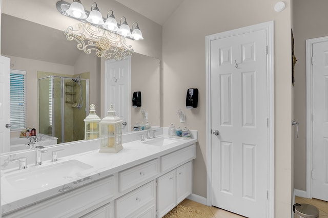 bathroom with vaulted ceiling, a sink, tile patterned flooring, and a stall shower