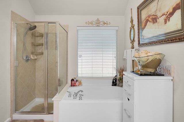 full bath featuring plenty of natural light, a bath, and a stall shower