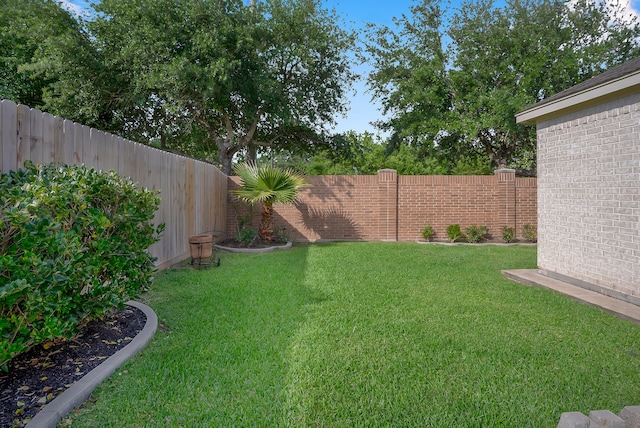 view of yard with a fenced backyard