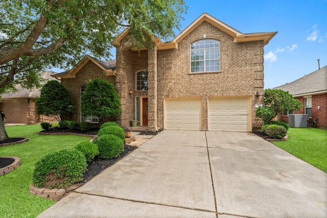 5211 Bur Oak Dr, Pasadena, TX 77505 - traditional-style house with a garage, a front yard, brick siding, central AC unit, and concrete driveway