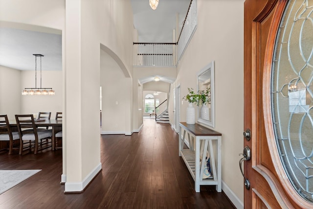 5211 Bur Oak Dr, Pasadena, TX 77505 - entrance foyer with baseboards, arched walkways, dark wood-style floors, and stairway
