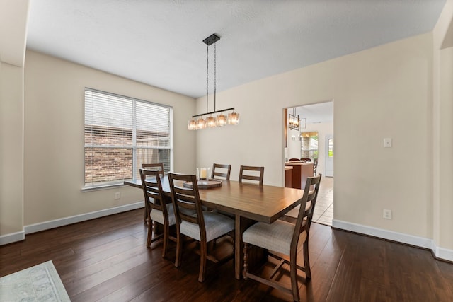 5211 Bur Oak Dr, Pasadena, TX 77505 - dining space featuring dark wood-type flooring, baseboards, a chandelier, and a healthy amount of sunlight