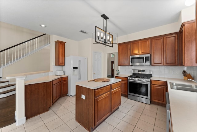 5211 Bur Oak Dr, Pasadena, TX 77505 - kitchen with a sink, stainless steel appliances, backsplash, a kitchen island, and visible vents