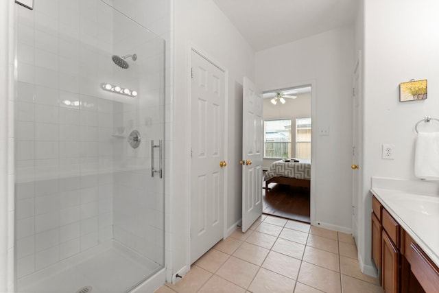 5211 Bur Oak Dr, Pasadena, TX 77505 - ensuite bathroom with baseboards, a ceiling fan, tile patterned floors, and a shower stall