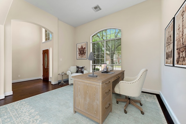 5211 Bur Oak Dr, Pasadena, TX 77505 - office area featuring visible vents, arched walkways, baseboards, and wood finished floors