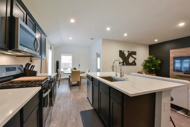 14417 Gray Rocks Rd, Splendora, TX 77372 - kitchen with stainless steel appliances, recessed lighting, a sink, and light wood-style floors