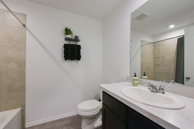 14417 Gray Rocks Rd, Splendora, TX 77372 - bathroom featuring visible vents, wood finished floors, vanity, baseboards, and toilet