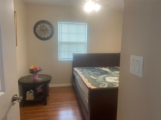 bedroom with baseboards and wood finished floors