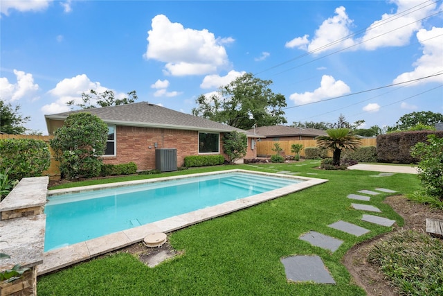 view of swimming pool with central air condition unit, a yard, a fenced in pool, and fence private yard