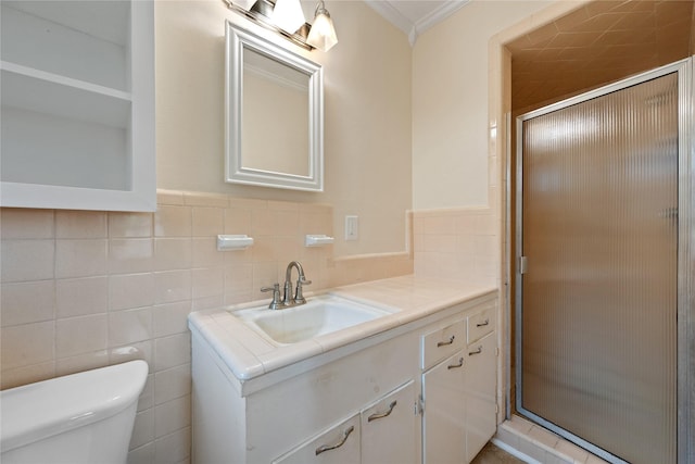 full bathroom featuring crown molding, tile walls, a stall shower, vanity, and toilet
