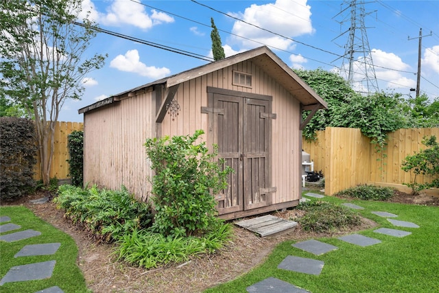 view of shed with fence