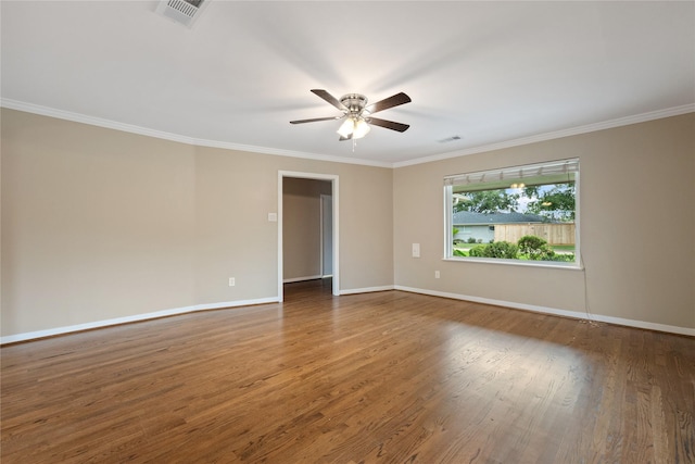 unfurnished room with wood finished floors, ornamental molding, ceiling fan, and visible vents