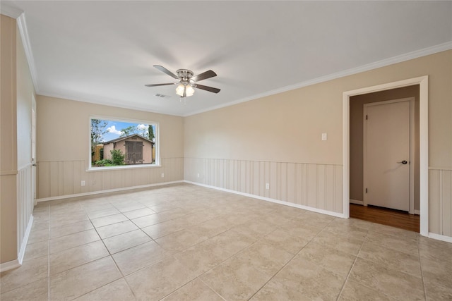 empty room with crown molding, a ceiling fan, visible vents, and light tile patterned flooring