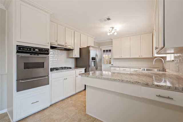 kitchen with visible vents, appliances with stainless steel finishes, a sink, a warming drawer, and under cabinet range hood
