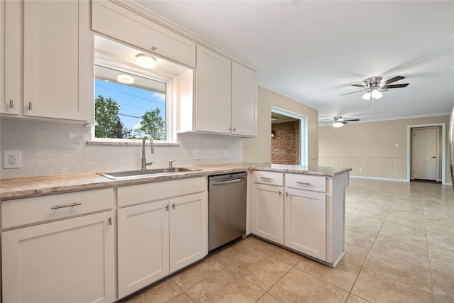 kitchen featuring a sink, a peninsula, dishwasher, and tasteful backsplash