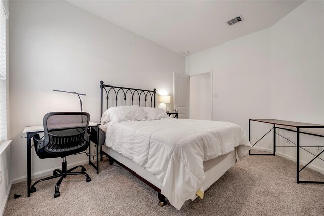 bedroom with carpet floors, baseboards, and visible vents