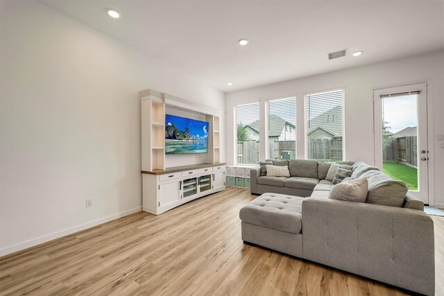 living room featuring recessed lighting, baseboards, visible vents, and light wood-style floors