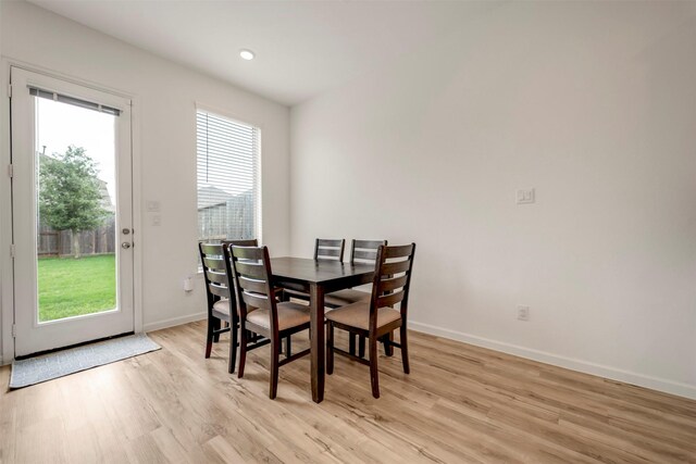 dining room with baseboards and light wood-type flooring