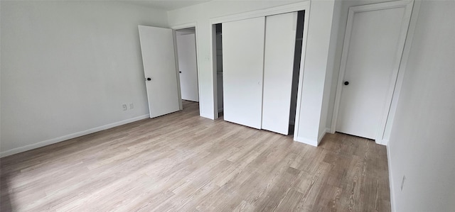 7810 Bunker Wood Ln, Houston, TX 77086 - unfurnished bedroom featuring a closet, baseboards, and wood finished floors