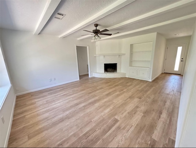 7810 Bunker Wood Ln, Houston, TX 77086 - unfurnished living room featuring visible vents, baseboards, a ceiling fan, and beamed ceiling