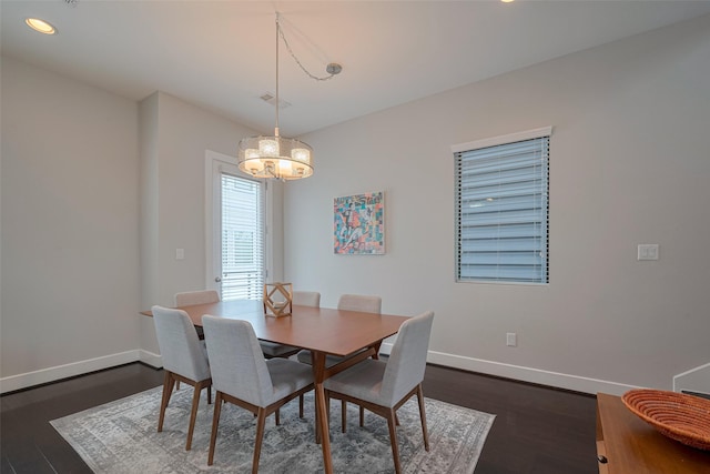 dining space with baseboards, recessed lighting, dark wood finished floors, and a notable chandelier