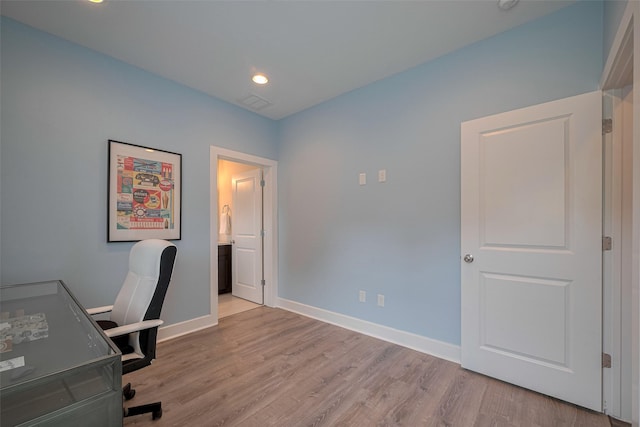 unfurnished office featuring baseboards, recessed lighting, wood finished floors, and visible vents