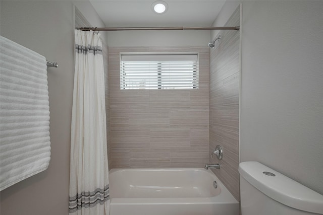 bathroom with shower / bath combo and toilet