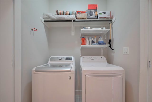 clothes washing area with laundry area and washer and clothes dryer