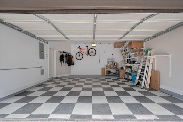 garage featuring baseboards and electric panel