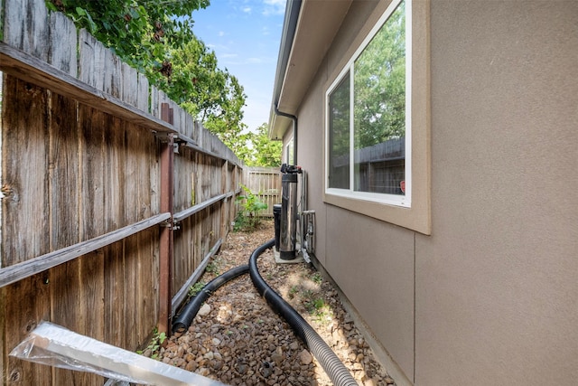 view of property exterior with fence and stucco siding