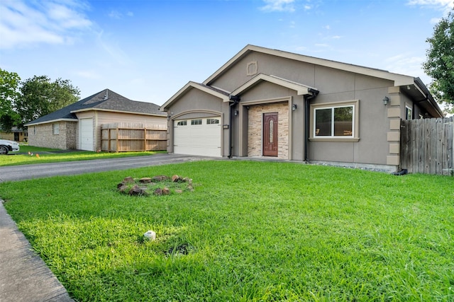ranch-style house with fence, an attached garage, aphalt driveway, stucco siding, and a front yard
