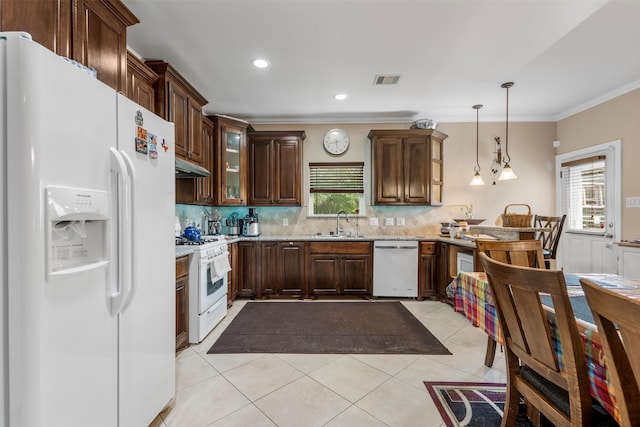 kitchen featuring crown molding, a sink, white appliances, decorative backsplash, and under cabinet range hood