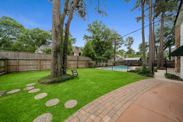 view of yard with a fenced backyard, a fenced in pool, and a patio