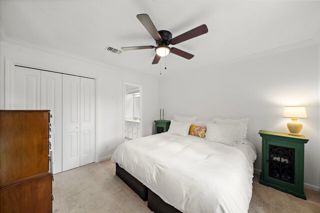 bedroom with crown molding, light colored carpet, visible vents, and a closet