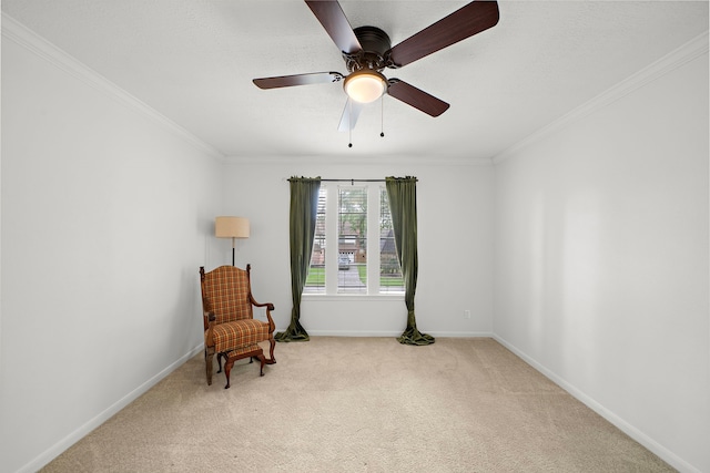 sitting room with crown molding, baseboards, and light colored carpet