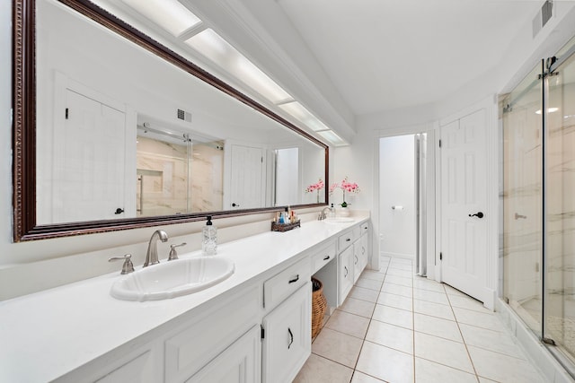 bathroom with a sink, a marble finish shower, tile patterned flooring, and visible vents