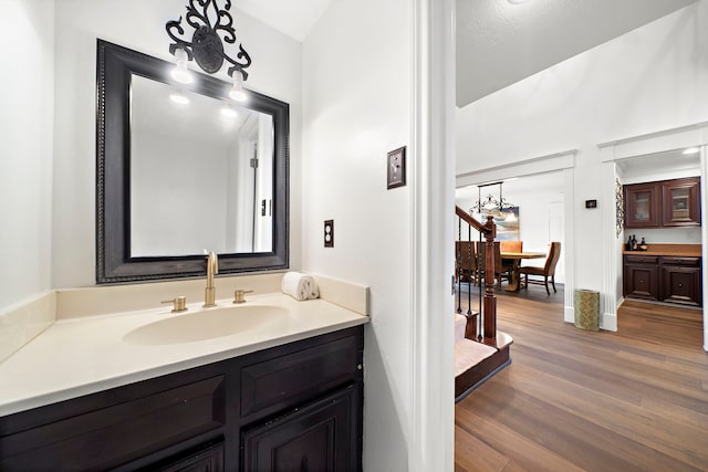bathroom featuring vanity, baseboards, and wood finished floors