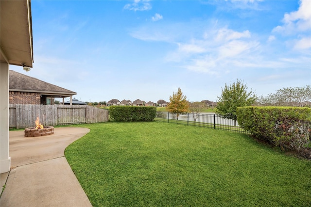 5331 Rue Dela Croix Dr, Katy, TX 77493 - view of yard featuring a fenced backyard, a water view, a fire pit, and a patio area