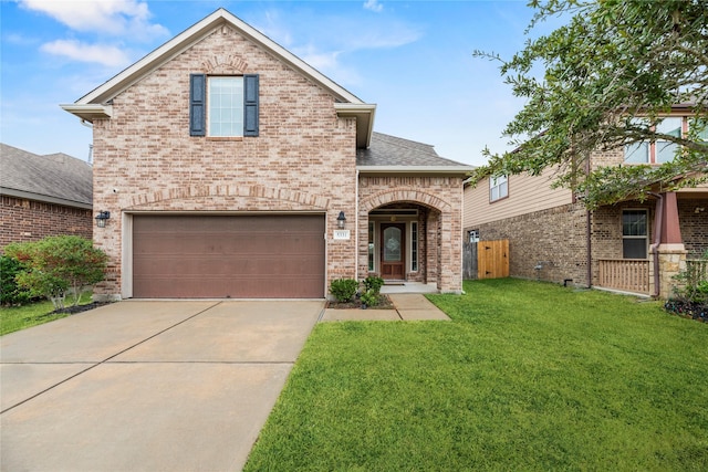 5331 Rue Dela Croix Dr, Katy, TX 77493 - traditional home with a front yard, roof with shingles, brick siding, concrete driveway, and an attached garage