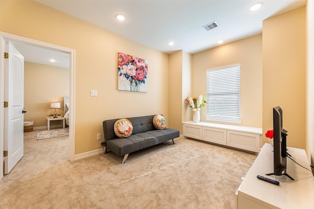 sitting room with baseboards, light carpet, recessed lighting, and visible vents