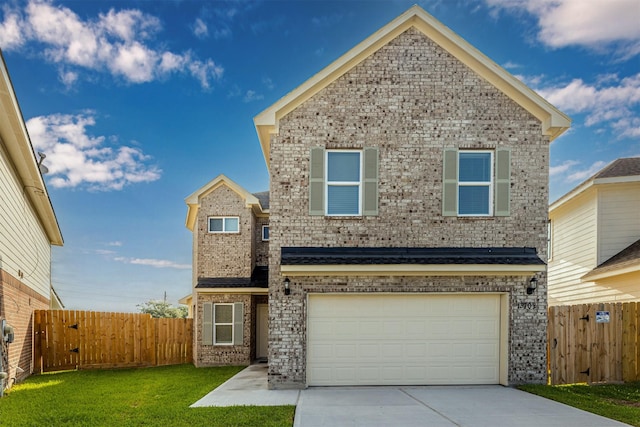 traditional-style home with fence, a front lawn, brick siding, a garage, and concrete driveway