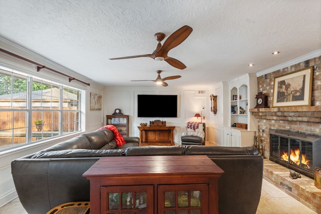 living room featuring a textured ceiling, a brick fireplace, a ceiling fan, and built in features
