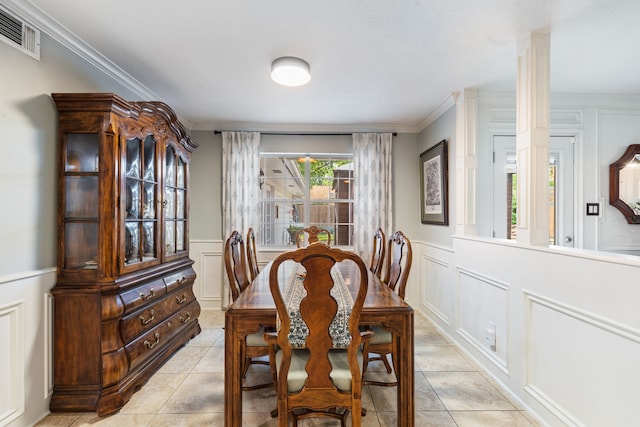 dining room featuring light tile patterned flooring, a decorative wall, visible vents, and decorative columns