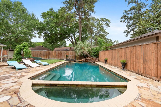 view of swimming pool with a fenced backyard, a patio, and a fenced in pool
