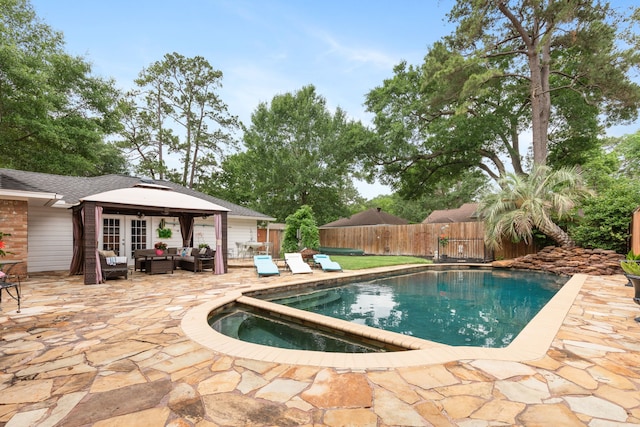 view of swimming pool with a patio, french doors, outdoor lounge area, fence private yard, and a fenced in pool