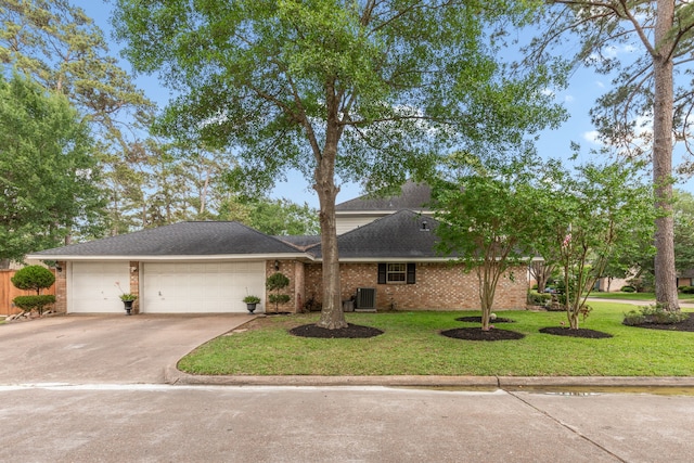 view of front of house featuring concrete driveway, a front lawn, brick siding, and a garage